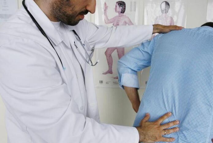 Doctor checking patient with pain in lower back