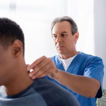 Doctor performs diagnostic examination on patient with neck pain.